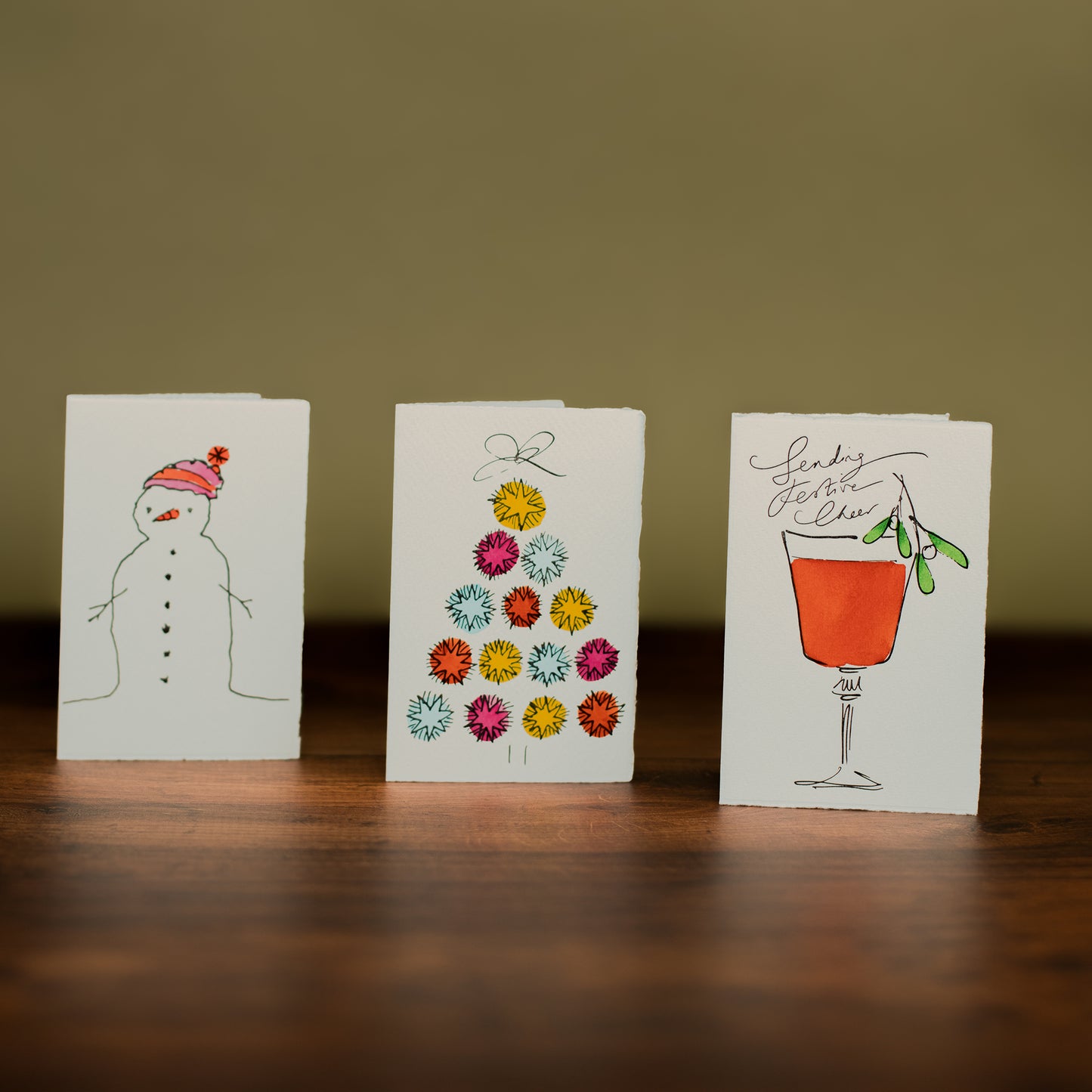 Illustrated Christmas Card Set on Wood Table